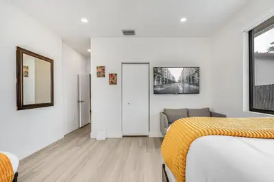 a white bedroom with a bed and a couch at Fox Sonata Downtown Pool House in Fort Lauderdale