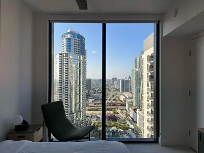 a bedroom with a view of a city from a window at Downtown Miami view - 38th floor gem in Miami