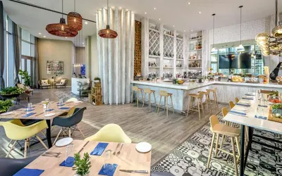 a restaurant with tables and chairs and a bar at Oceanfront Luxe Apt 24th Floor in Hollywood