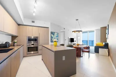 a kitchen and living room with a dining room at Oceanfront Luxe Apt 24th Floor in Hollywood