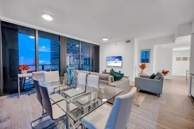a living room with a couch and a table and chairs at High Floor Unit Heart Of Miami with pool and gym in Miami