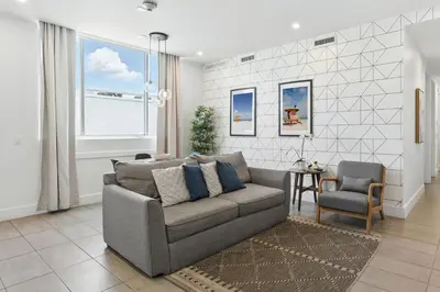 a living room with a couch and a chair at Modern South Beach 2 Bedroom Gem in Miami Beach