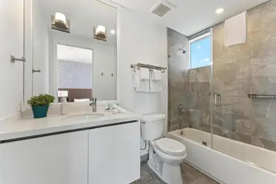 a bathroom with a toilet and a sink and a shower at Modern South Beach 2 Bedroom Gem in Miami Beach