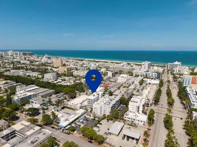 a blue balloon flying over a city with the ocean at Modern South Beach 2 Bedroom Gem in Miami Beach