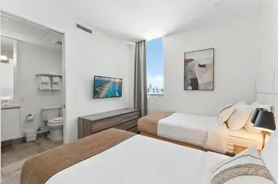 a hotel room with two beds and a bathroom at SoBe 2 Bedroom Near Ocean Drive in Miami Beach