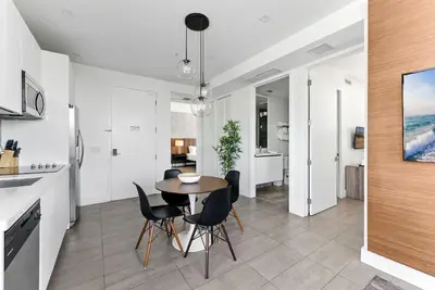 a kitchen and dining room with a table and chairs at SoBe 2 Bedroom Near Ocean Drive in Miami Beach
