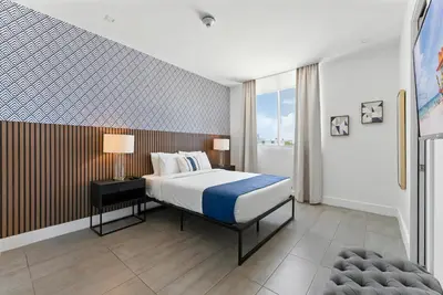 a bedroom with a king sized bed and a window at SoBe 2 Bedroom Near Ocean Drive in Miami Beach