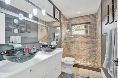 a bathroom with two sinks and a toilet at Trendy 4 Bedroom Pool Home Minutes from the Beach in Hollywood