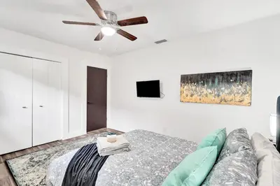 a living room with a couch and a ceiling fan at Trendy 4 Bedroom Pool Home Minutes from the Beach in Hollywood