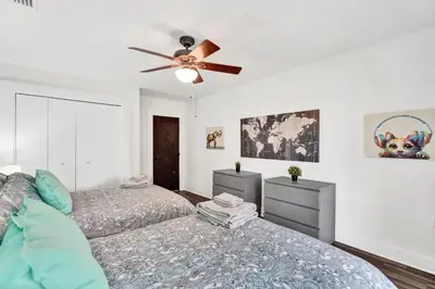 a bedroom with two beds and a ceiling fan at Trendy 4 Bedroom Pool Home Minutes from the Beach in Hollywood