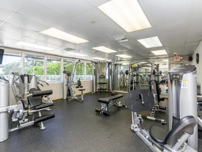a gym with several treadmills and machines at Pet Friendly Studio Beach and Pool Access, gym ! in Sunny Isles Beach