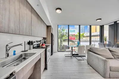 an open kitchen with a couch and a table at Amazing 3Beds 3Baths Corner Unit Downtown Miami in Miami