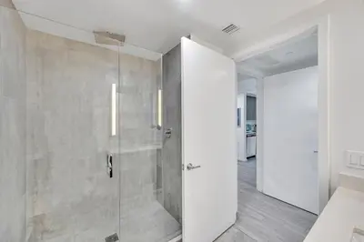 a bathroom with a shower with a glass door at Amazing 3Beds 3Baths Corner Unit Downtown Miami in Miami