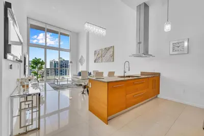 a kitchen with a sink and a counter top at 40th floor High Ceilings unit at icon brickell in Miami