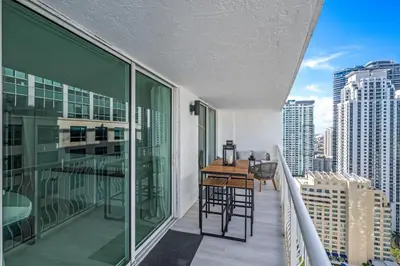 a balcony with a table and chairs on a building at High Rise Unit in the heart of Brickell in Miami