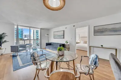 a living room with a glass table and chairs at Superb private unit with amenities and parking in Miami