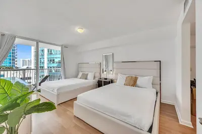 a bedroom with two beds and a large window at Superb private unit with amenities and parking in Miami