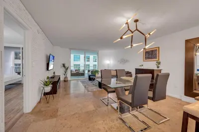 a dining room and living room with a table and chairs at Amazing unit location with amenities & parking in Miami