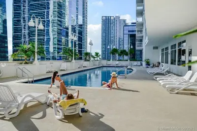 a group of people playing in the swimming pool at a hotel at Luxurious 34th floor Ocean view Private Unit in Miami
