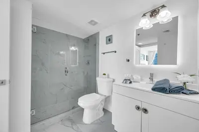 a white bathroom with a toilet and a shower at Luxurious 34th floor Ocean view Private Unit in Miami