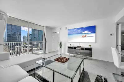 a living room with a couch and a tv at Luxurious 34th floor Ocean view Private Unit in Miami