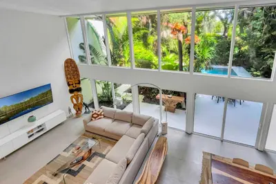 a living room with a couch and a skateboard at Wonderful Tropical Pool House Miami Coconut Grove in Miami
