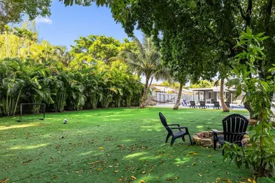 two chairs sitting in the grass in a park at Luxe 4BR Miami Pool-Near Airport-Games-Backyard in Miami