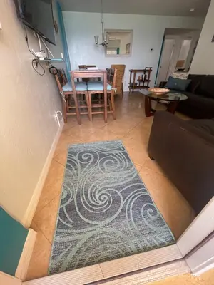 a living room with a rug on the floor at Modern Beachfront Suite at Hollywood Broadwalk in Hollywood