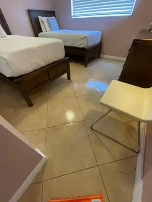 a room with two beds and a table and a chair at Modern Beachfront Suite at Hollywood Broadwalk in Hollywood