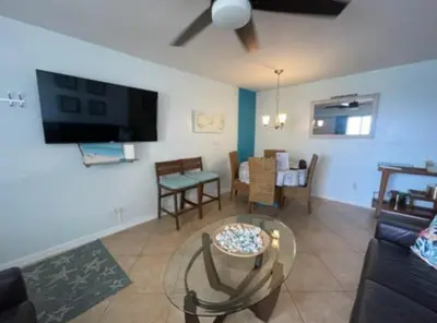a living room with a couch and a table at Modern Beachfront Suite at Hollywood Broadwalk in Hollywood