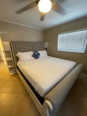 a bedroom with a bed with a blue bag on it at Modern Beachfront Suite at Hollywood Broadwalk in Hollywood