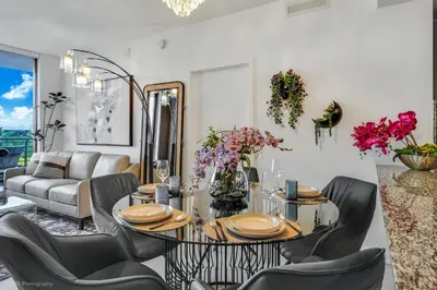 a dining room with a table and chairs at Stylish 3BD-3BR at the Heart of Downtown Doral with Top Amenities & Golf in Miami