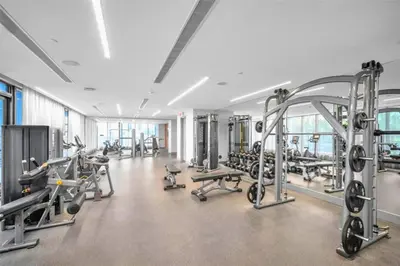 a gym with several treadmills and machines at Stylish 3BD-3BR at the Heart of Downtown Doral with Top Amenities & Golf in Miami