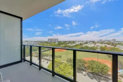 a balcony with a view of a baseball field at Stylish Miami Condo with Beach Access at 72 Park in Miami Beach