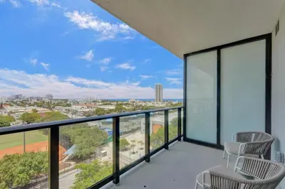 a balcony with chairs and a view of the city at Stylish Miami Condo with Beach Access at 72 Park in Miami Beach