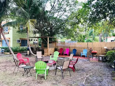 a group of chairs and tables in a yard at Stylish 2br apt, king-size bed, 5mins to the beach - J3 in Hollywood