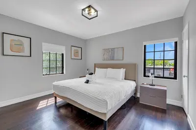 a white bedroom with a large bed and two windows at Wonderful Tropical Pool House Miami South Brickell in Miami