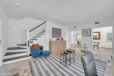 a living room with blue chairs and a staircase at Wonderful Tropical Pool House Miami South Brickell in Miami