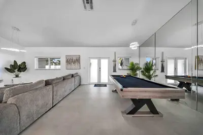 a living room with a pool table and a couch at Luxury Villa Serena Heated Pool 15 min to Beach in Miami