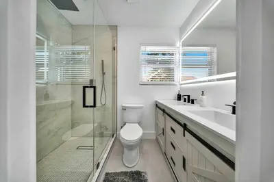 a bathroom with a shower and a toilet and a sink at Luxury Villa Serena Heated Pool 15 min to Beach in Miami