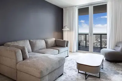 a living room with a couch and a large window at 2 Bed & 2 Bath at Beachwalk - Amazing View on 29th in Hallandale Beach