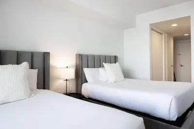 two beds sitting next to each other in a bedroom at Epic 29th-Floor Studio at Beachwalk Resort in Hallandale Beach