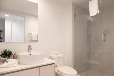 a bathroom with a toilet and a sink and a shower at Epic 29th-Floor Studio at Beachwalk Resort in Hallandale Beach