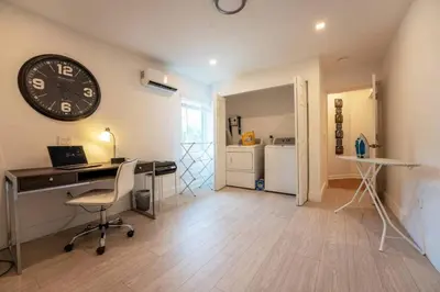 a room with a desk and a clock on the wall at Secluded Villa with 3 bedrooms and Heated Pool in Miami Beach