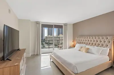 a bedroom with a large bed and a large window at WATERFRONT Luxury 3 Bed 3 Bath Suite in Hallandale Beach