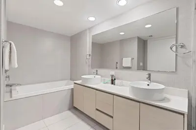a bathroom with two sinks and a large mirror at WATERFRONT Luxury 3 Bed 3 Bath Suite in Hallandale Beach