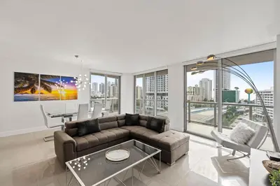 a living room with a couch and a table at WATERFRONT Luxury 3 Bed 3 Bath Suite in Hallandale Beach