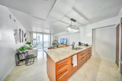 a kitchen with a sink and a counter top at South City Suites in Hallandale Beach
