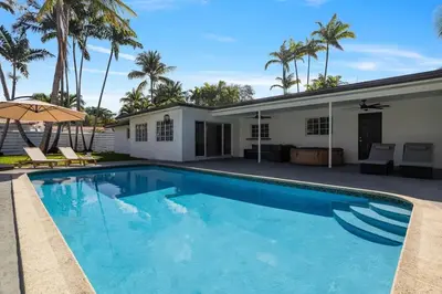 a swimming pool in front of a house with palm trees at Modern Hollywood 3BR House Pool Jacuzzi in Hollywood