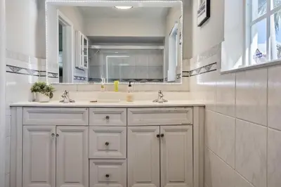 a bathroom with a sink and a mirror at Modern Hollywood 3BR House Pool Jacuzzi in Hollywood